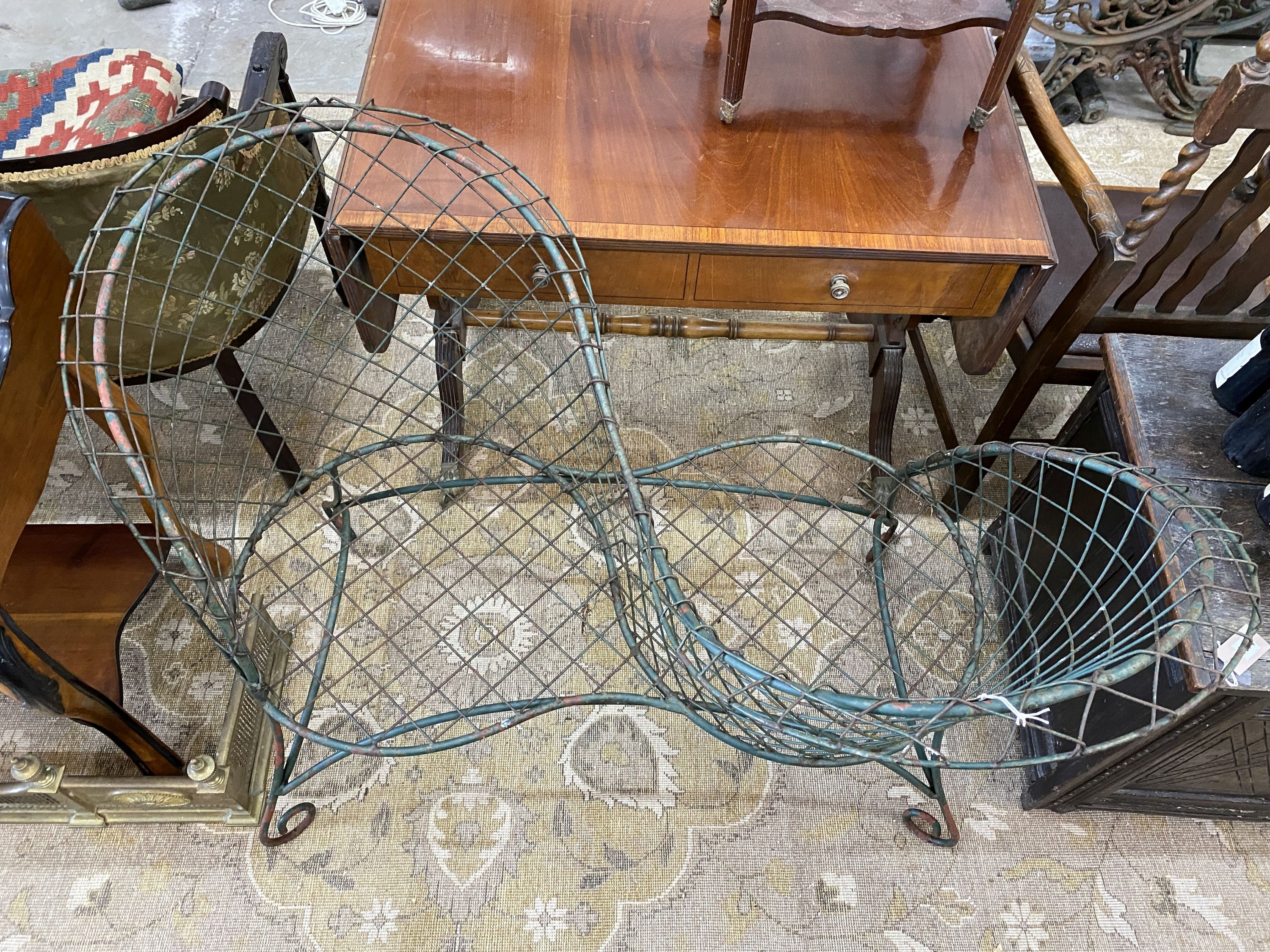 A painted wrought iron and wirework garden love seat, width 126cm, depth 50cm, height 90cm